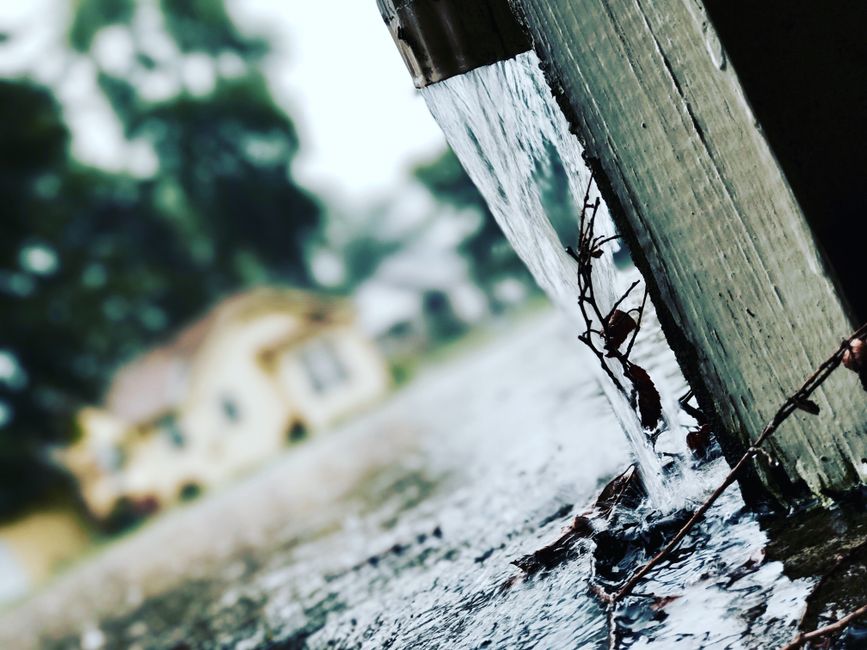 Seamless gutter and downspout along the corner of a home