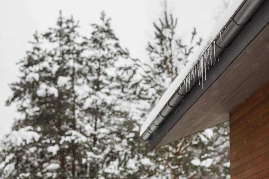 Snow and ice resting along a gutter guard during winter